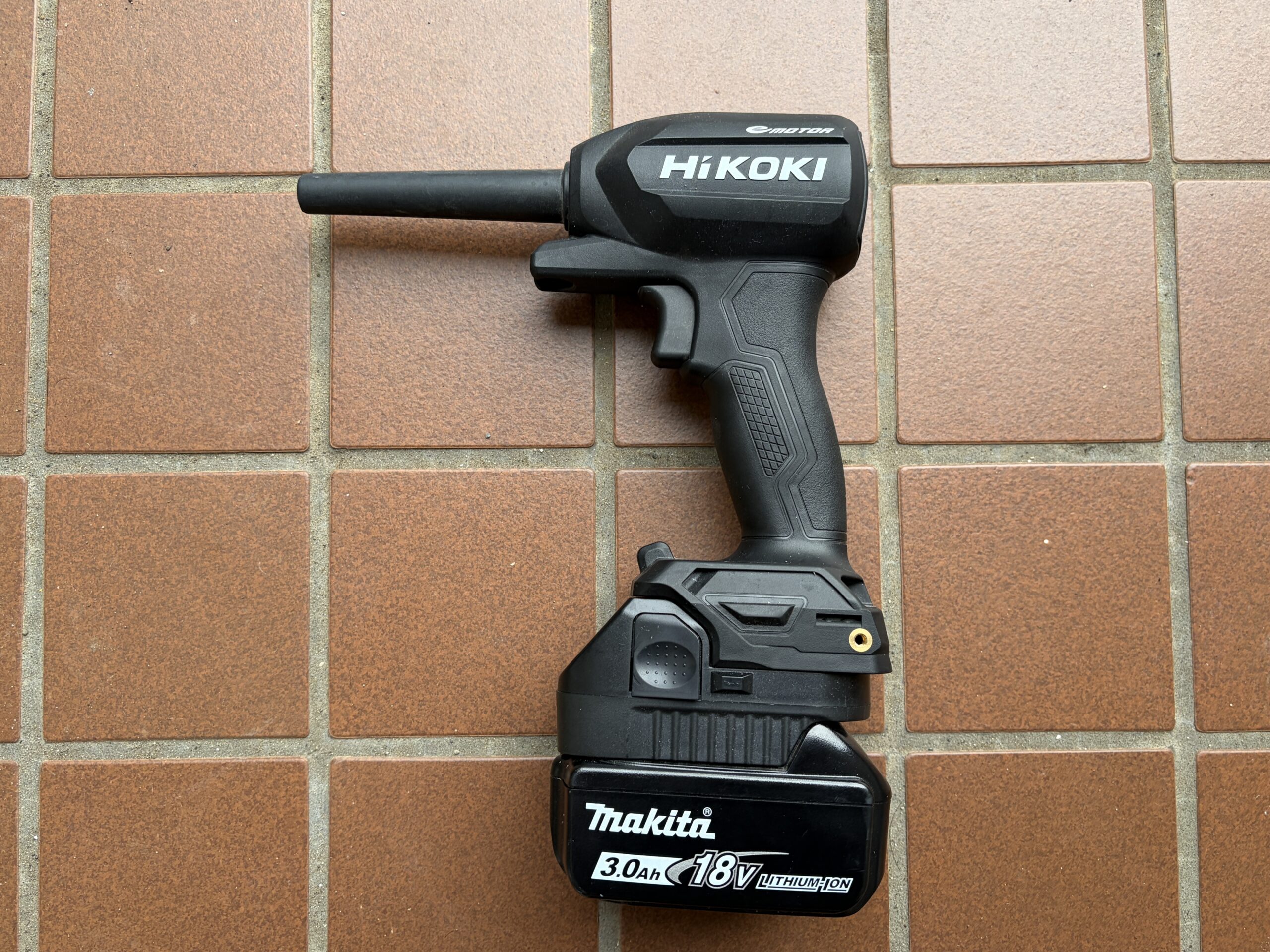 HiKOKIのコードレスエアダスターRA18DAを側面から撮影した画像。黒い本体のHiKOKIロゴ、長いエアノズル、グリップ、18Vバッテリーを装着した状態の全体形状が確認できる。